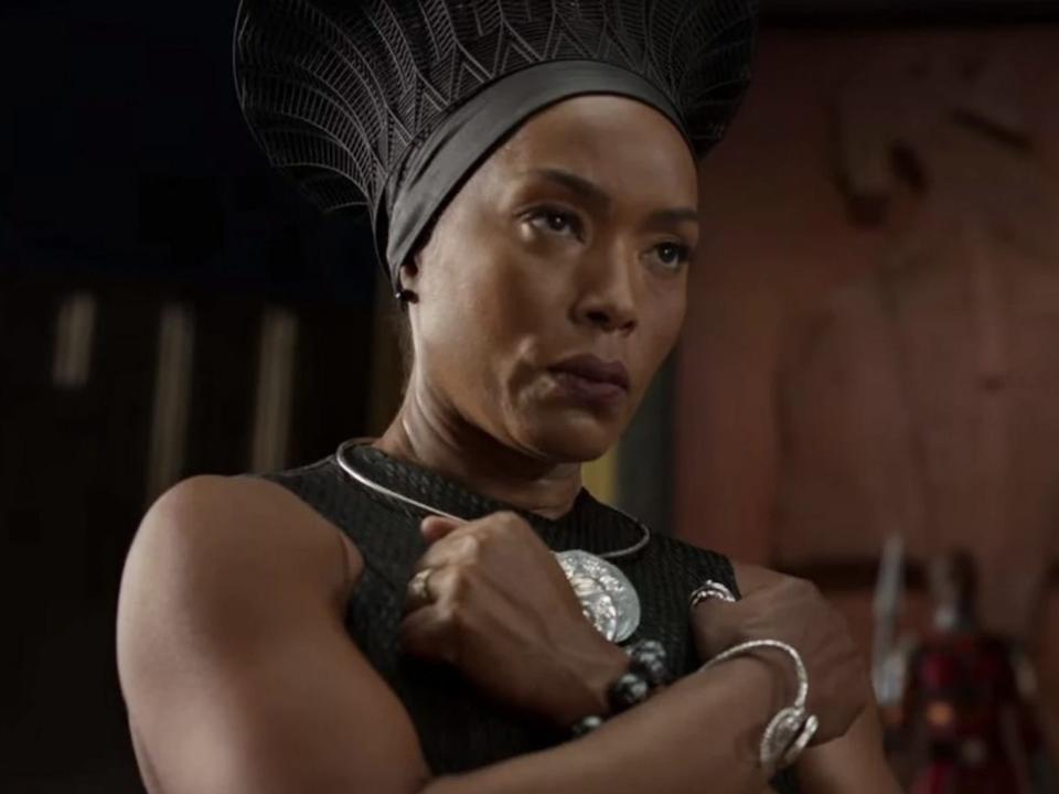 Angela Bassett as Queen Ramonda doing the Wakanda Forever salute.