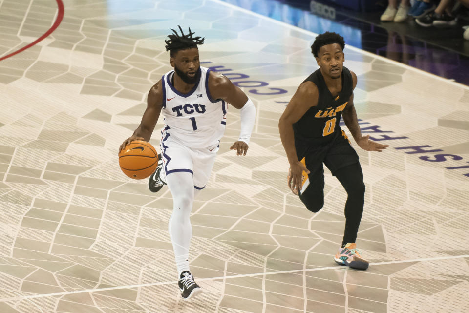 TCU guard Mike Miles Jr. (1) dribbles the ball down the floor past Arkansas-Pine Bluff guard Trejon Ware (0) in the first half of an NCAA college basketball game in Fort Worth, Texas, Monday, Nov. 7, 2022. (AP Photo/Emil Lippe)