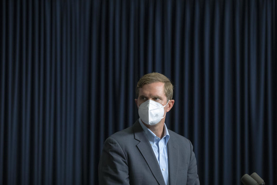 Kentucky Gov. Andy Beshear wears a mask while a video from a health care professional is played during a media briefing about the COVID-19 pandemic at the state Capitol in Frankfort, Ky., on Monday, Aug. 23, 2021. (Ryan C. Hermens/Lexington Herald-Leader via AP)