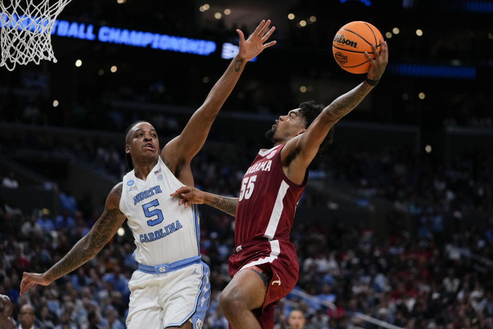 Alabama guard Aaron Estrada (55) shoots over North Carolina forward Armando Bacot (5) during the first half of a Sweet 16 college basketball game in the NCAA tournament Thursday, March 28, 2024, in Los Angeles. (AP Photo/Ryan Sun)