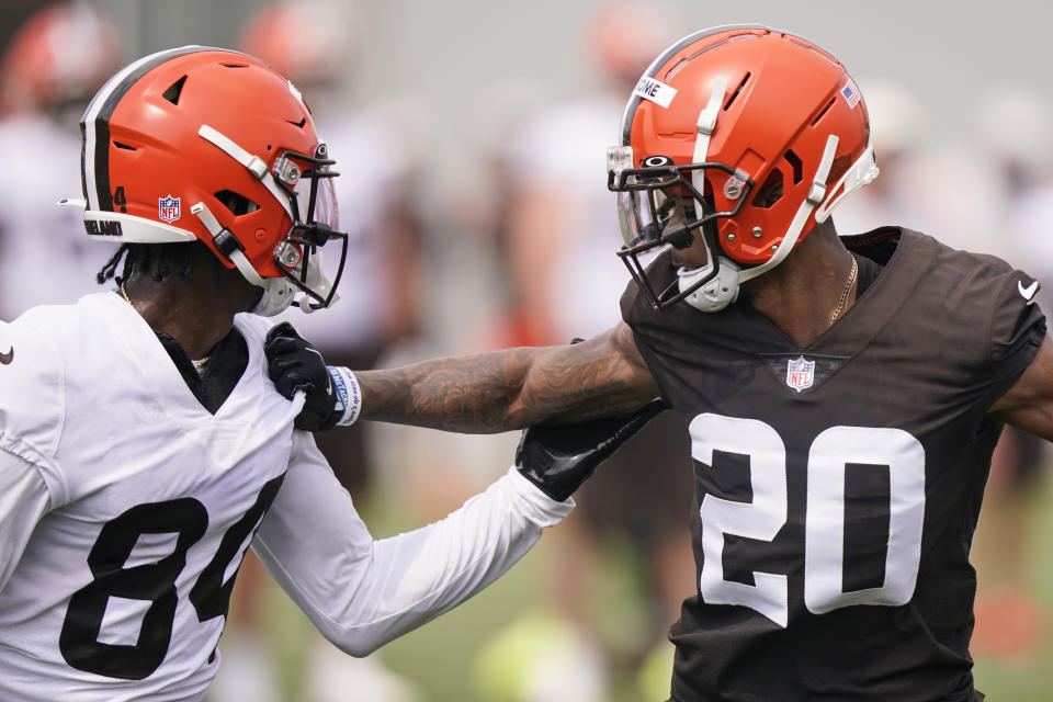 Cleveland Browns cornerback Greg Newsome II (20) and Cleveland Browns wide receiver Ja'Marcus Bradley (84) run a drill during an NFL football practice, Saturday, July 31, 2021, in Berea, Ohio. (AP Photo/Tony Dejak)