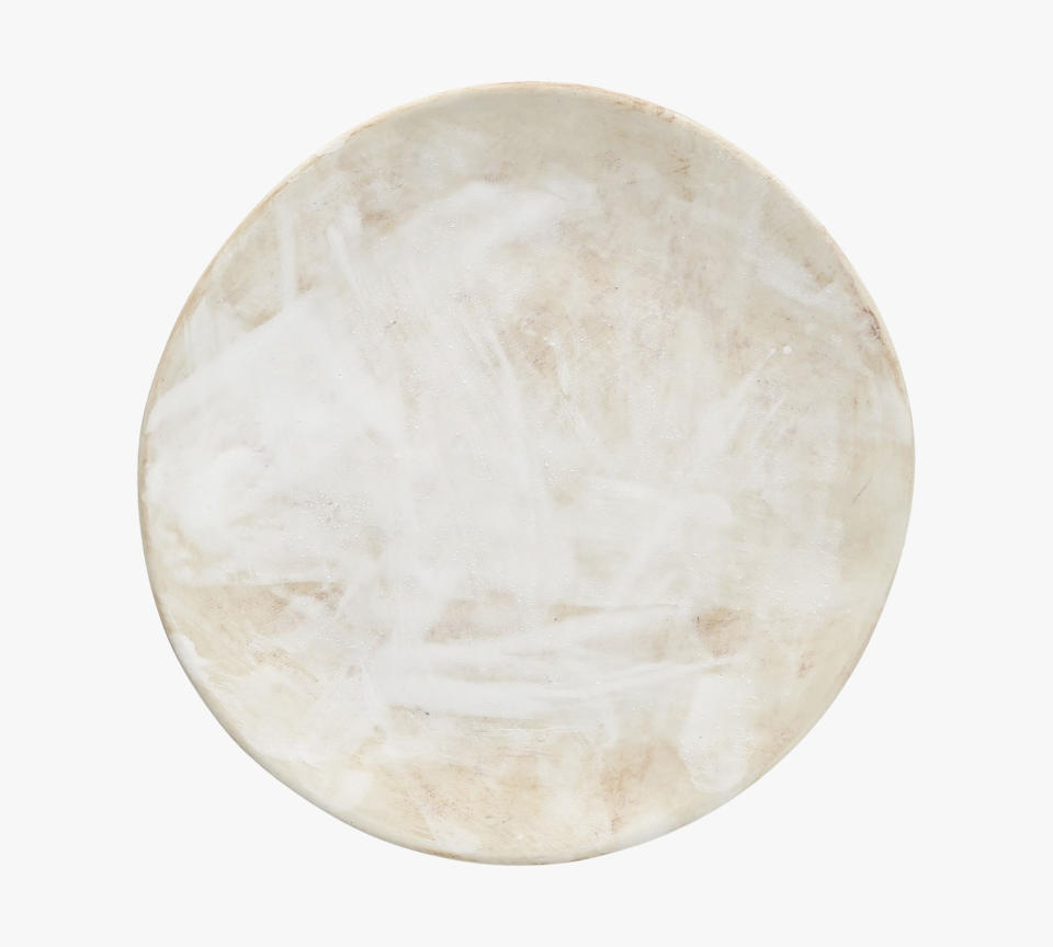 This image provided by Pottery Barn shows a dining plate. The Northern Lights are evoked in a palette of greys on this namesake stoneware collection from Fortessa. Many chefs are using creative dishware designed with irregular shapes and unusual colors to help create a mood. (Pottery Barn via AP).