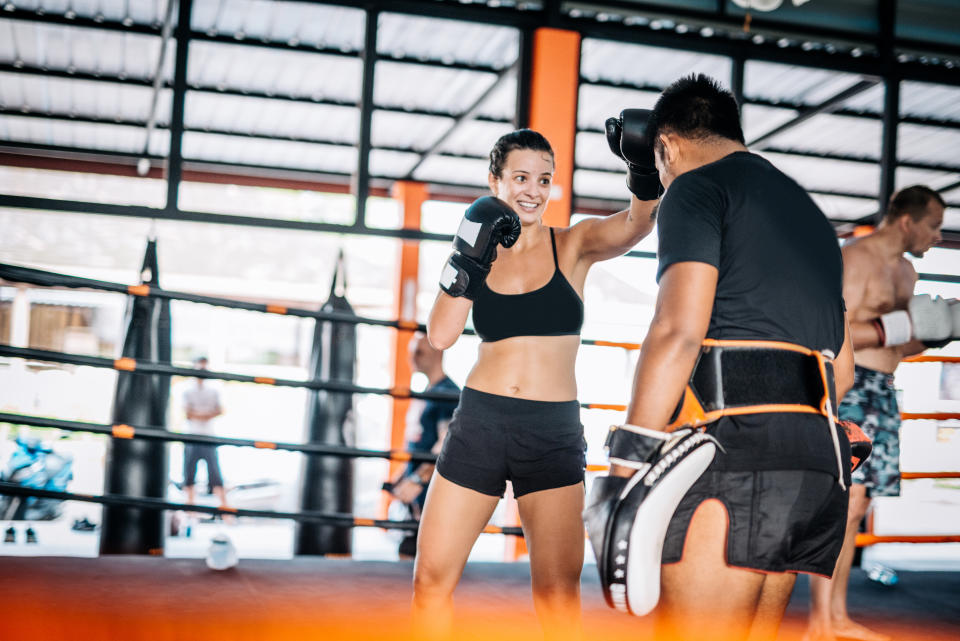 Martial arts are physical activities good for both men and women, recreational athletes or professional fighters. Many people coming to Thailand to practice and improve their technique with experienced local Muay Thai and MMA trainers. Woman using elbow technique to hit the focus mat