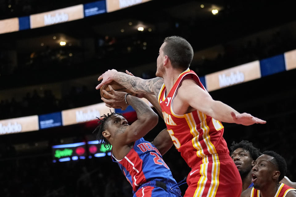 Detroit Pistons guard Marcus Sasser (25) has his shot blocked by Atlanta Hawks guard Garrison Mathews (25) during the first half of an NBA basketball game Monday, Dec. 18, 2023, in Atlanta. (AP Photo/John Bazemore)