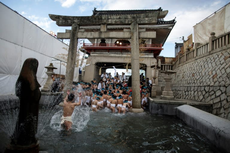 Japanese boys step out of a fountain after being purified during the boys' event in the annual Naked Man Festival or 'Hadaka Matsuri'at Saidaiji Temple in Okayama, western Japan