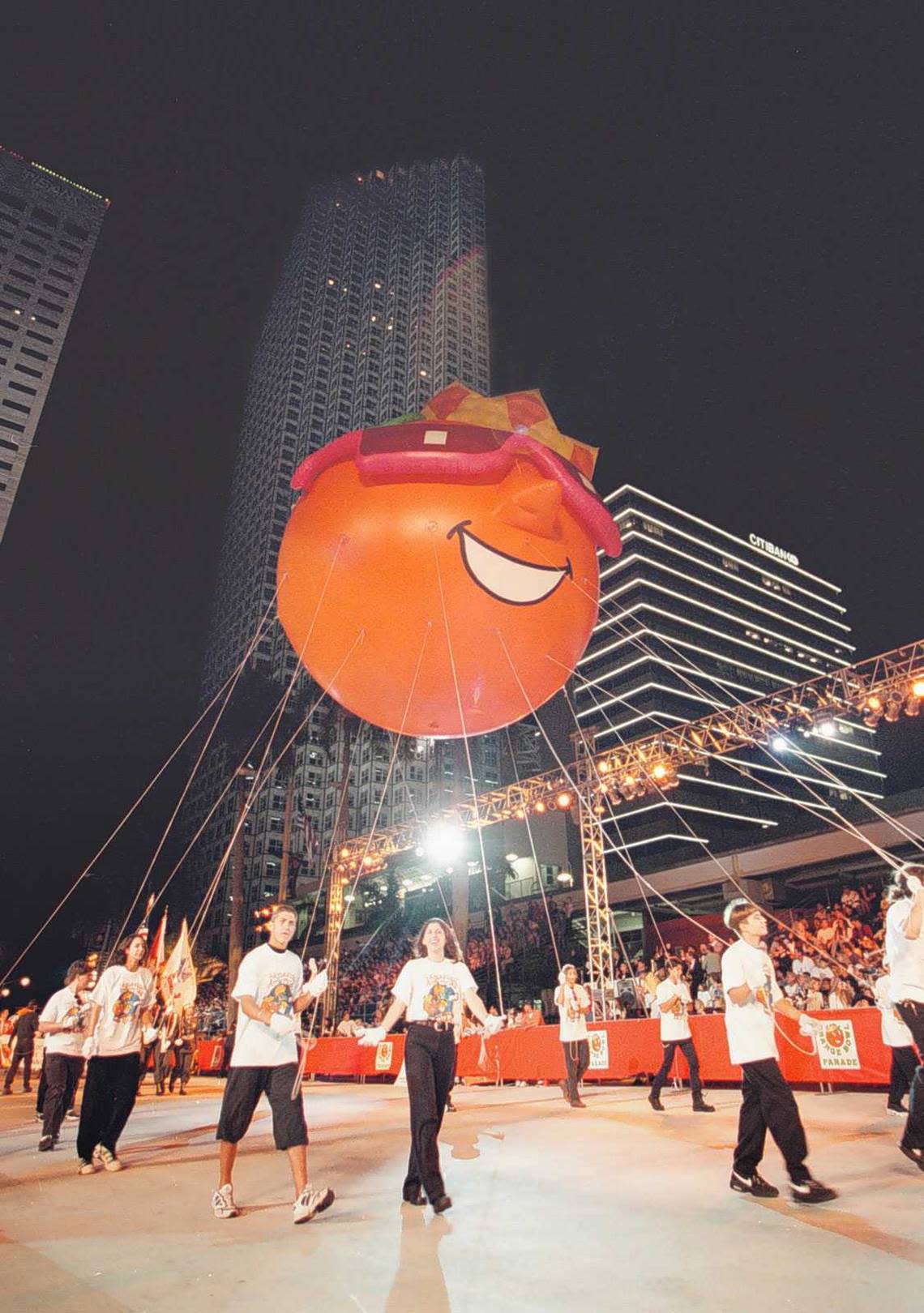 The King Orange balloon makes it way down Biscayne Boulevard in downtown Miami during the annual Orange Bowl Parade.