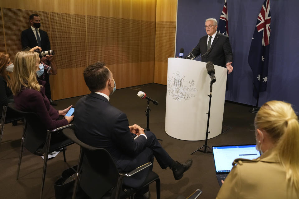 Australian Prime Minister Scott Morrison talks about the situation in Ukraine at a news conference in Sydney, Wednesday, Feb. 23, 2022. Australia has announced additional sanctions on Russia and is warning businesses to prepare for retaliation through Russian cyberattacks. Morrison said Wednesday that targeted financial sanctions and travel bans will be a first batch of measures in response to Russian aggression toward Ukraine. (AP Photo/Rick Rycroft)