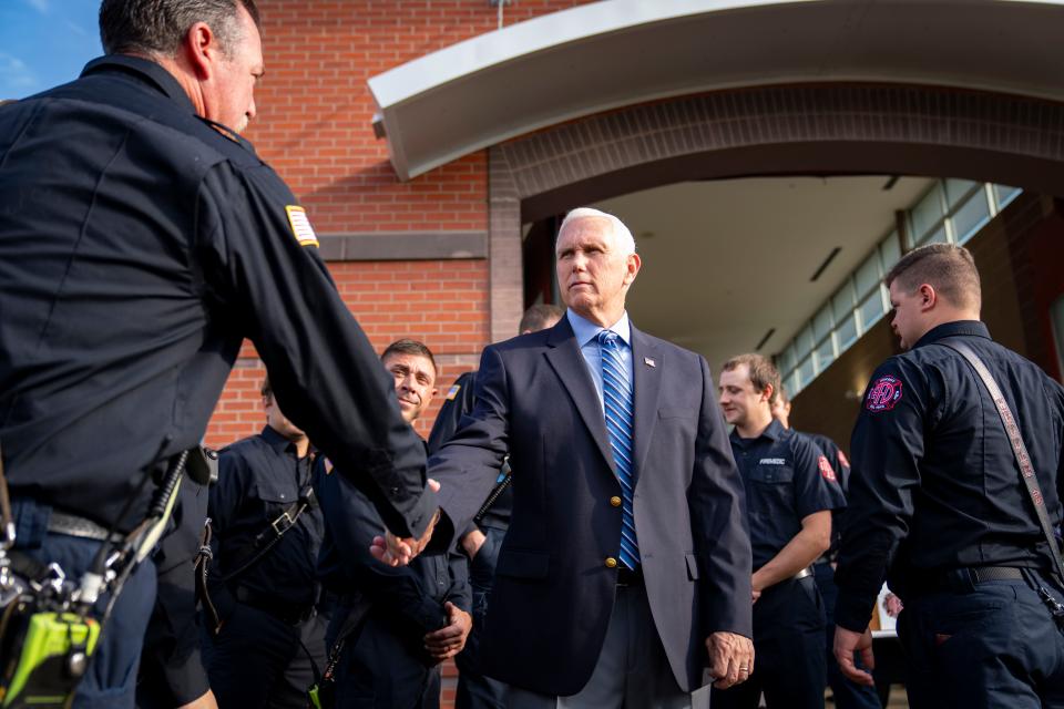 Republican presidential candidate former Vice President Mike Pence talks with firefighters during a 9/11 remembrance ceremony at the Ankeny Fire Department, Monday, Sept. 11, 2023.