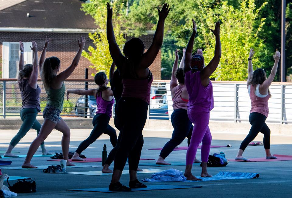 Visitors participate in yoga during the opening weekend at Montgomery Whitewater in Montgomery, Ala., on Saturday July 8, 2023.