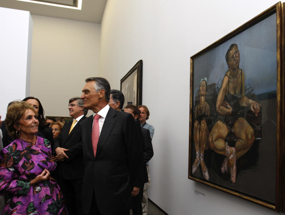 FILE - Portuguese-British artist Paula Rego, left, and Portugal's President Anibal Cavaco Silva stand next to Rego's "Dancing Ostriches", Friday, Sept. 18 2009, during the inauguration of the Casa Das Historias, house of the stories, a museum dedicated to her work in Cascais, outside Lisbon. Rego, who created bold, visceral works inspired by fairy tales, her homeland and her own life, has died on Wednesday, June 8, 2022 at the age of 87. (AP Photo/Joao Henriques, File)