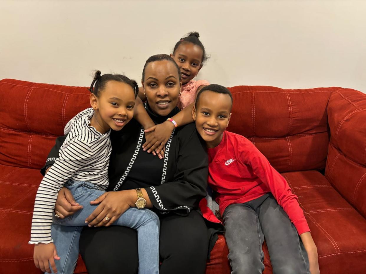 Aline Muhongayire with three of her children. Ian is on the right, Geila on the left and Erica is behind. Her oldest child is not pictured. (Submitted by Aline Muhongayire - image credit)