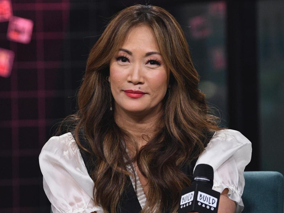 Carrie Ann Inaba holding a microphone at the BUILD Speaker Series in January 2019.