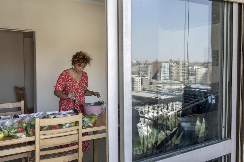 Basma Mostafa, a 30-year-old journalist who founded an initiative that sends freshly home cooked meals to quarantined coronavirus patients, package food at her friend's apartment, in Cairo, Egypt. Saturday, July 11, 2020. Mostafa, who works with others to coordinate the volunteer effort, said she got the idea of helping out when she was going through a difficult time. "I thought that to alleviate my suffering, I can engage with the suffering of others and feel more for them," she said. "I derive my strength and perseverance from the patients." (AP Photo/Nariman El-Mofty)