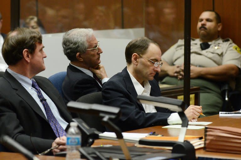 Defendant Christian Gerhartsreiter (R) sits with his attorneys Jefferey Denner (C) and Brad Bailey as they listen to the prosecutor during his murder trial at Los Angeles Superior Court on March 18, 2013. The German who posed as a Rockefeller family member after allegedly killing a man in California explained the freshly-dug soil in his back yard as plumbing work, a witness said