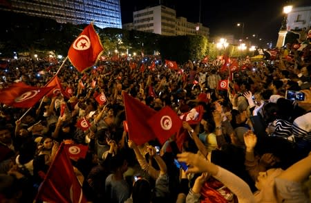 People react after exit poll results were announced in a second round runoff of the presidential election in Tunis