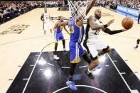 May 22, 2017; San Antonio, TX, USA; San Antonio Spurs shooting guard Jonathon Simmons (17) shoots the ball as Golden State Warriors power forward Draymond Green (23) defends during the second half in game four of the Western conference finals of the NBA Playoffs at AT&T Center. Mandatory Credit: Soobum Im-USA TODAY Sports