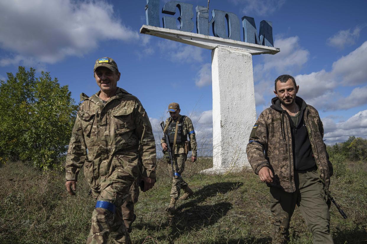 Soldiers of Ukrainian armed forces walk to their position in the recently retaken area of Izium, Ukraine, Monday, Sept. 19, 2022. Residents of Izium, a city recaptured in a recent Ukrainian counteroffensive that swept through the Kharkiv region, are emerging from the confusion and trauma of six months of Russian occupation, the brutality of which gained worldwide attention last week after the discovery of one of the world's largest mass grave sites. (AP Photo/Evgeniy Maloletka)