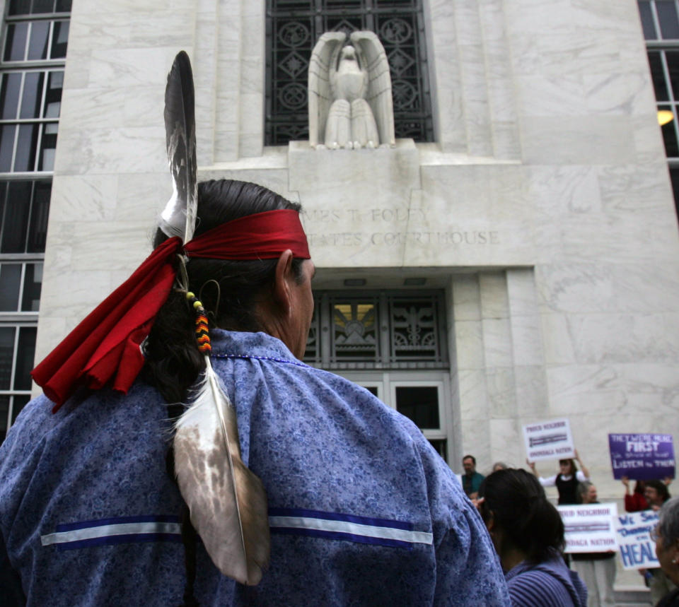 FILE - This Oct. 11, 2007 file photo shows Jake Edward of the Onondaga Council of Chiefs standing outside the federal courthouse in Albany, N.Y., after arguments were heard in the Onondaga Indian Nation's land claim case against New York state. A Native American nation is asking the international community to charge the United States with human rights violations in hopes of getting help with a land claim. The Onondaga Indian Nation says it plans to file a petition at the Organization of American States on Tuesday, seeking human rights violations against the United States government. They want the Inter-American Commission on Human Rights to declare that the U.S. government’s decision not to hear their lawsuit asking for the return of 2.5 million acres in upstate New York to be violations of international human rights agreements. (AP Photo/Mike Groll, File)