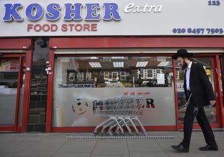 An orthodox Jewish man walks past a shop in Golders Green north London, Britain May 3, 2016. REUTERS/Hannah McKay