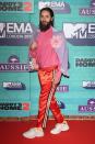 <p>Jared Leto always likes making a statement, wearing bright orange silk tracksuit pants, pink top and lilac blazer.</p>