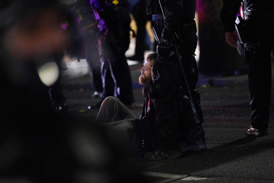 Portland police arrest a man during protests, Saturday, Sept. 26, 2020, in Portland. The protests, which began over the killing of George Floyd, often result frequent clashes between protesters and law enforcement. (AP Photo/John Locher)