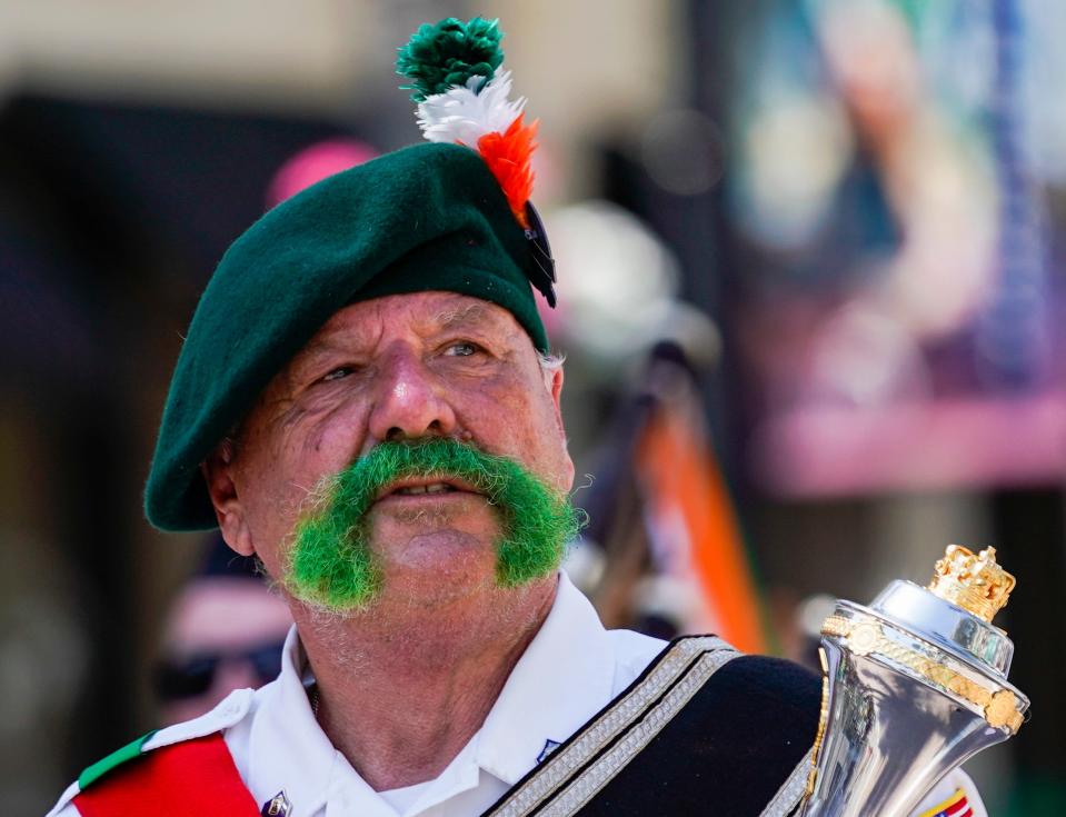 John McMahon, Guns ’N’ Hoses band master, leads the band with a dyed mustache during the 2023 St. Patrick’s Day Parade in downtown Naples. The band plays BackStreets Sports Bar's St. Patrick's Day party this Sunday.