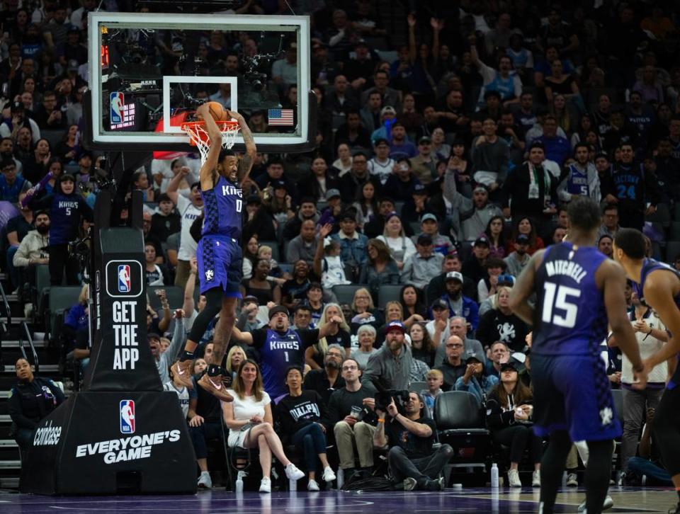 Sacramento Kings guard Malik Monk (0) reverse dunks the ball during a game at Golden 1 Center on Tuesday, March 26, 2024 in Sacramento.