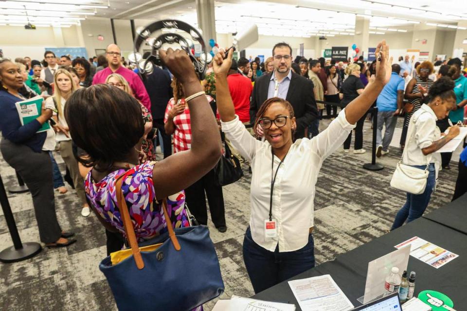Laticia Dorsey, left, and Keisha Hill celebrate after Dorsey secured a teaching assistant position at Jacquet Middle School during a Fort Worth Independent School District-wide teacher hiring fair at the FWISD Teaching and Learning Center on Thursday, July 27, 2023.