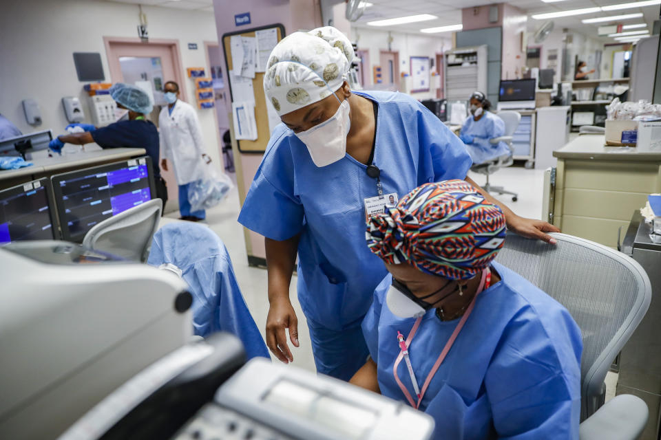 FILE - In this May 27, 2020, file photo, medical personnel work in the emergency department at NYC Health + Hospitals Metropolitan in New York. As coronavirus rages out of control in other parts of the U.S., New York is offering an example after taming the nation’s deadliest outbreak this spring — but also trying to prepare in case another surge comes. (AP Photo/John Minchillo, File)