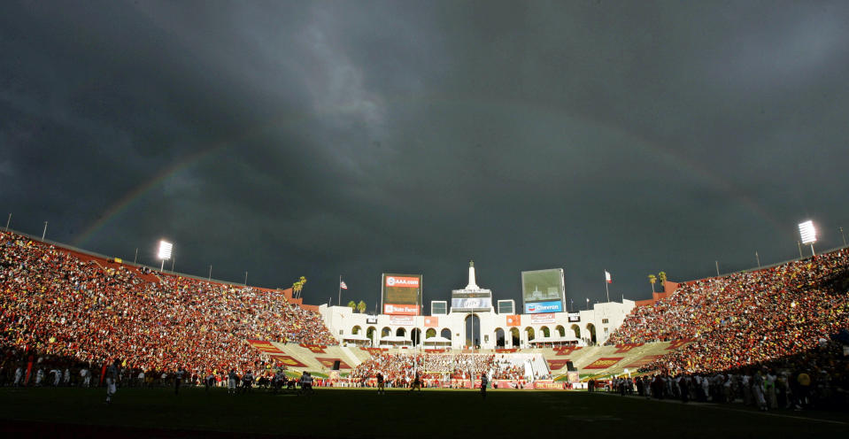 FILE - In this Sept. 22, 2007 file photo, a rainbow forms over the Los Angeles Memorial Coliseum during the Southern California and Washington State NCAA college football game in Los Angeles. The University of Southern California's sale of naming rights for Los Angeles Memorial Coliseum is being criticized as dishonoring the historic stadium's dedication as a memorial to soldiers who fought and died in World War I. USC announced last year that the stadium will be renamed United Airlines Memorial Coliseum as part of a $270 million renovation of the facility, which opened in 1923. (AP Photo/Chris Carlson, File)