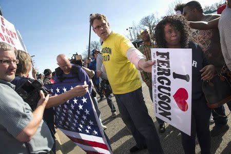 Ferguson resident, Blake Ashby, tries to separate Michael Brown supporters from Ferguson police supporters, outside the Ferguson Police Department and Municipal Court in Ferguson, Missouri, March 15, 2015. REUTERS/Kate Munsch