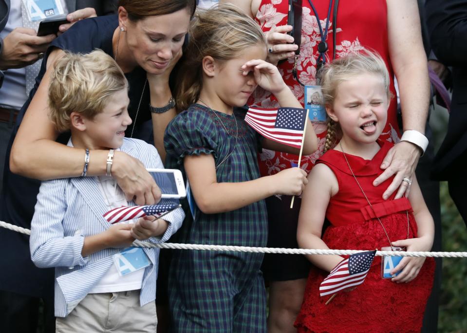 Children react as the helicopter lands