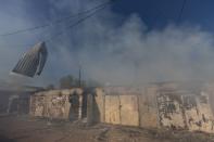 FILE PHOTO: A garage burns following a military strike on a garage near the railway station, amid Russia's invasion of Ukraine, in the frontline city of Lyman, Donetsk region