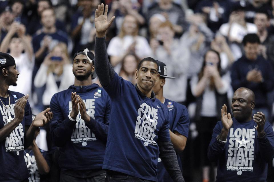 Connecticut coach Kevin Ollie waves to fans at a pep rally Tuesday, April 8, 2014, in Storrs, Conn., the day after the team won the NCAA men's Division I basketball championship. (AP Photo/Jessica Hill)
