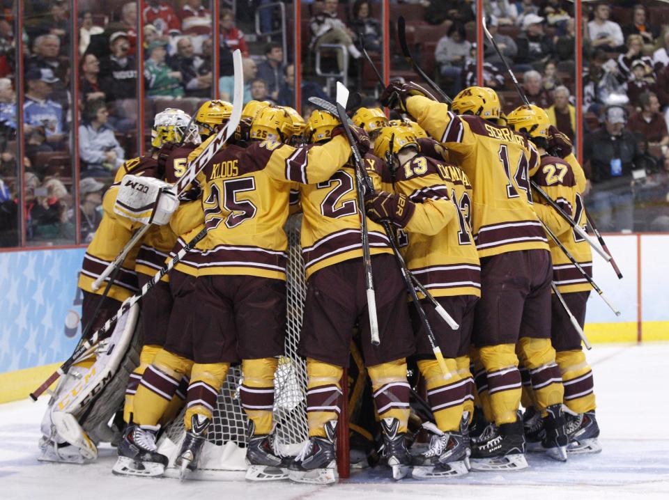 Minnesota players huddle around the goal before an NCAA men's college hockey Frozen Four tournament game against North Dakota, Thursday, April 10, 2014, in Philadelphia. (AP Photo/Chris Szagola)