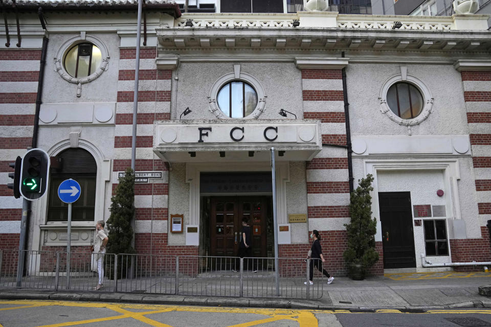 People walk past the Hong Kong Foreign Correspondents' Club in Hong Kong, Friday, Nov. 5, 2021. China has criticized a press freedom survey, Friday, from the Hong Kong Foreign Correspondents' Club that found nearly half its members were considering leaving the city. The survey said the members are concerned about a decline in press freedoms under a sweeping new national security law imposed by Beijing following massive anti-government protests in 2019. (AP Photo/Kin Cheung)