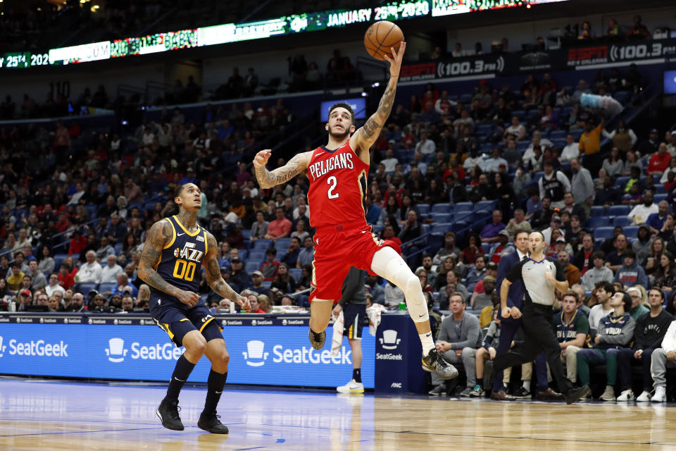 New Orleans Pelicans guard Lonzo Ball (2) catches a pass in front of Utah Jazz guard Jordan Clarkson (00) in the first half of an NBA basketball game in New Orleans, Monday, Jan. 6, 2020. (AP Photo/Tyler Kaufman)