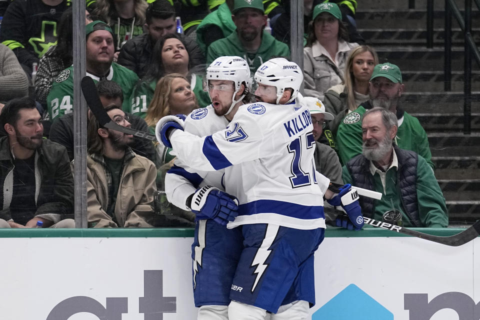 Tampa Bay Lightning's Anthony Cirelli (71) and Alex Killorn (17) celebrate after Cirelli scored in the second period of an NHL hockey game against the Dallas Stars, Saturday, Feb. 11, 2023, in Dallas. (AP Photo/Tony Gutierrez)