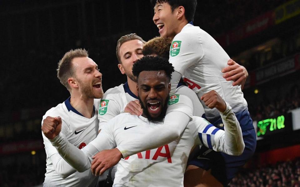 Danny Rose celebrates with his Spurs teammates after Dele Alli had doubled their lead at the Emirates - AFP