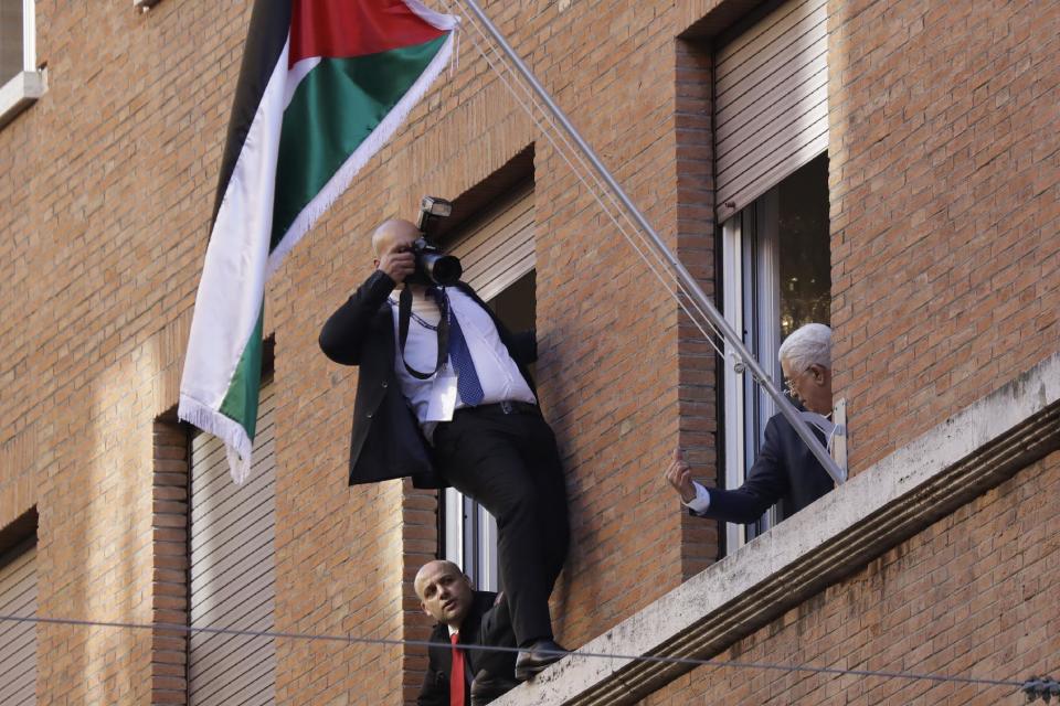 Palestinian President Mahmoud Abbas, right, looks out a window of the newly inaugurated Palestinian embassy to the Holy See at the Vatican, Saturday, Jan. 14, 2017. (AP Photo/Andrew Medichini)