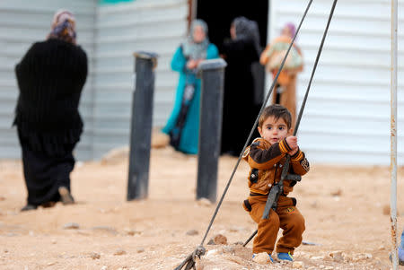 A Syrian refugee child plays before the arrival of actor Angelina Jolie, UNHCR Special Envoy, at the Al Zaatri refugee camp, in the Jordanian city of Mafraq, near the border with Syria, January 28, 2018. REUTERS/Muhammad Hamed T