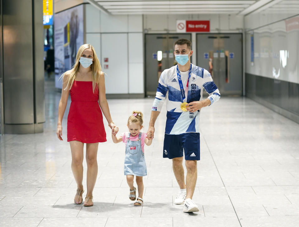 Olympic gymnast Max Whitlock, with his wife Leah and daughter Willow, as he arrives back at London Heathrow Airport from the Tokyo 2020 Olympic Games. Picture date: Tuesday August 3, 2021.