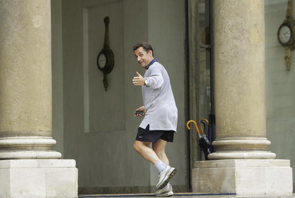 FILE - In this Thursday, May 17, 2007 file picture, French President Nicolas Sarkozy gestures towards reporters as he steps into the Elysee Palace, coming back from a run in Paris, France. The trial of former French President Nicolas Sarkozy concludes Tuesday in Paris, after a month during which the court sought to determine whether he broke laws on campaign financing in his unsuccessful 2012 re-election bid. (AP Photo/Christophe Ena, File)