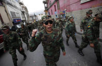 A female Air Force Sergeant joins the third day of protests by low ranking soldiers in La Paz, Bolivia, Thursday, April 24, 2014. The soldiers marched for a third day against the military high command's dismissal of four of its leaders who defended their call for better career opportunities. Enlisted men and women are demanding changes so that non-commissioned officers in Bolivia's military may study to become career officers. (AP Photo/Juan Karita)