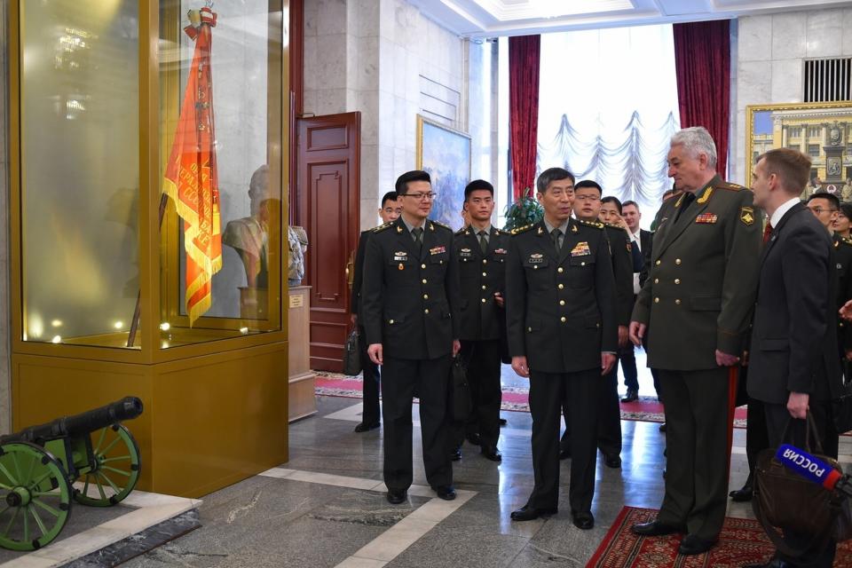 In this handout photo released by Russian Defense Ministry Press Service, Chief of the Military Academy of the General Staff f of the Armed Forces of the Russian Federation Col. Gen. Vladimir Zarudnitsky, second right, and China's Defense Minister Gen. Li Shangfu, second left, pay a visit to the Military Academy of the General Staff of the Armed Forces of the Russian Federation in Moscow, Russia, Monday, April 17, 2023. (Russian Defense Ministry Press Service via AP)