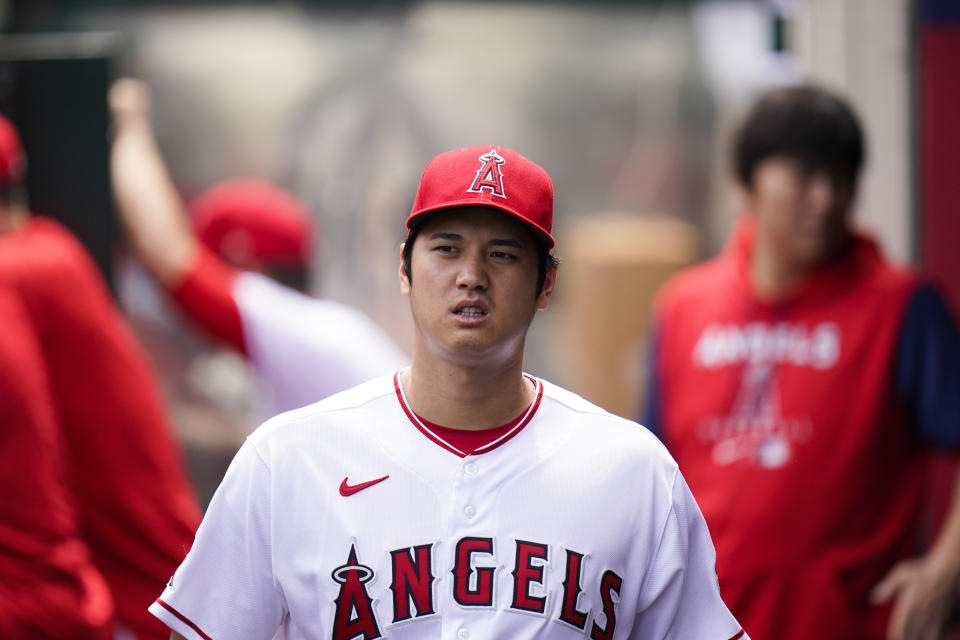 Los Angeles Angels' Shohei Ohtani, of Japan, walks across the dugout during the first inning of a baseball game against the Houston Astros, Sunday, Sept. 4, 2022, in Anaheim, Calif. (AP Photo/Jae C. Hong)