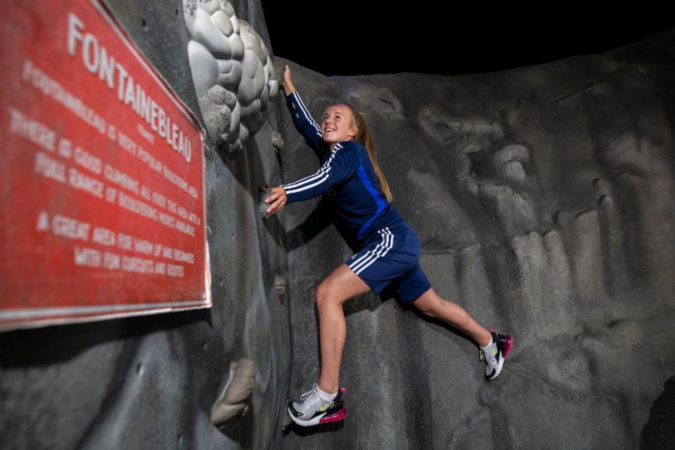 A youngster takes on the climbing wall at the Bear Grylls Adventure (PA)