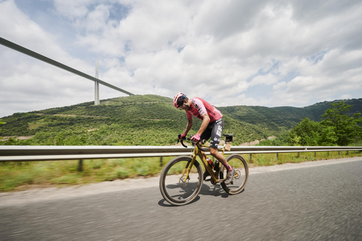  Toby Perry on a solo attack under the Millau Viaduct en route to victory at UCI Gravel World Series event at Wish One Millau 