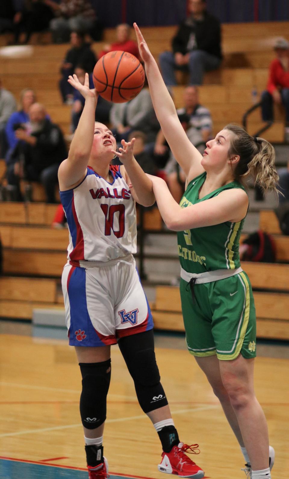 Newark Catholic senior Maddie Kauble blocks a shot from Licking Valley senior Emma Cubbison during their Licking County League game on Tuesday, Dec. 6, 2022. Kauble scored 21 points to lift the visiting Green Wave to a 48-27 victory.