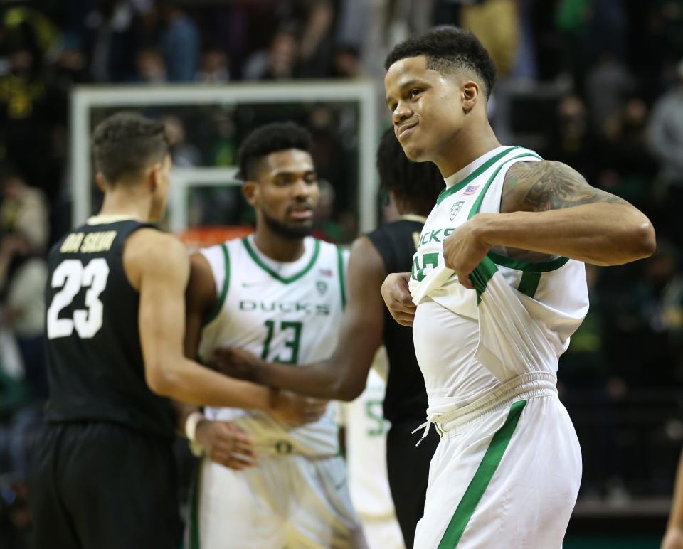 Oregon's Jacob Young, right, grimaces at the end of the game as Colorado leaves town with the win.